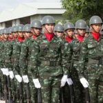 Serious ethnic soldiers lining up during military ceremony