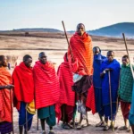 Photo of Group of Men Wearing Assorted Scarves Holding Sticks