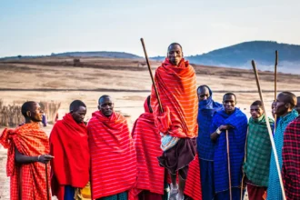 Photo of Group of Men Wearing Assorted Scarves Holding Sticks