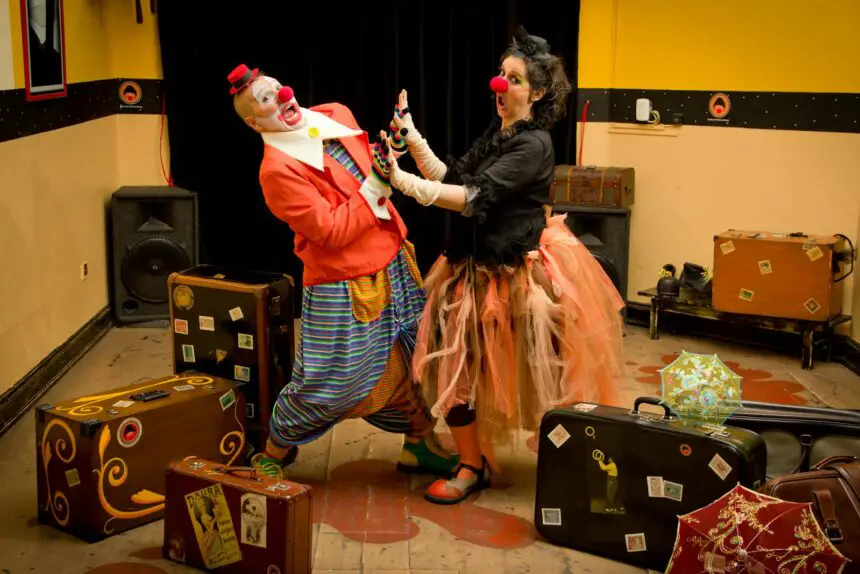 Meaning of Acting and Actor: Clowns performing indoors with vibrant costumes and stage props, capturing joyful fun.