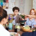 Family values: A happy group of friends and family enjoying a meal together indoors. Perfect for themes of togetherness and joy.